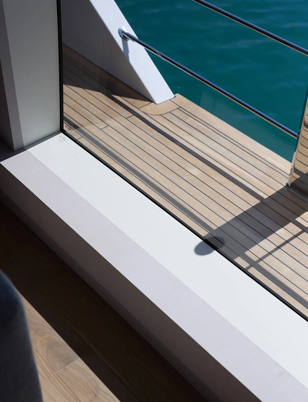 A close up shot of the teak decks onboard the superyacht Custom Line 106 take from inside the yacht