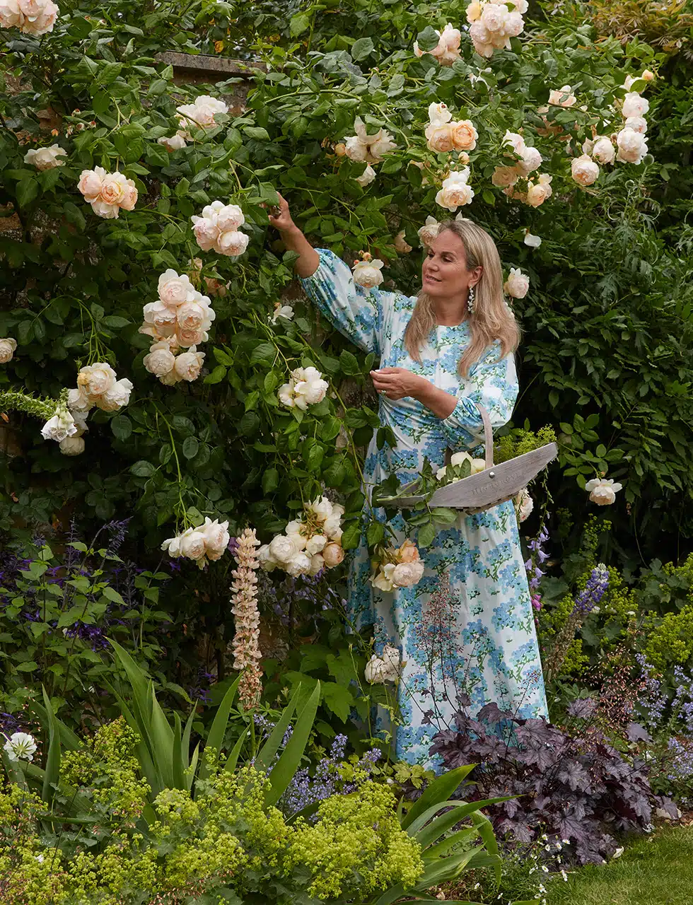 Katharine Pooley picking roses in her garden