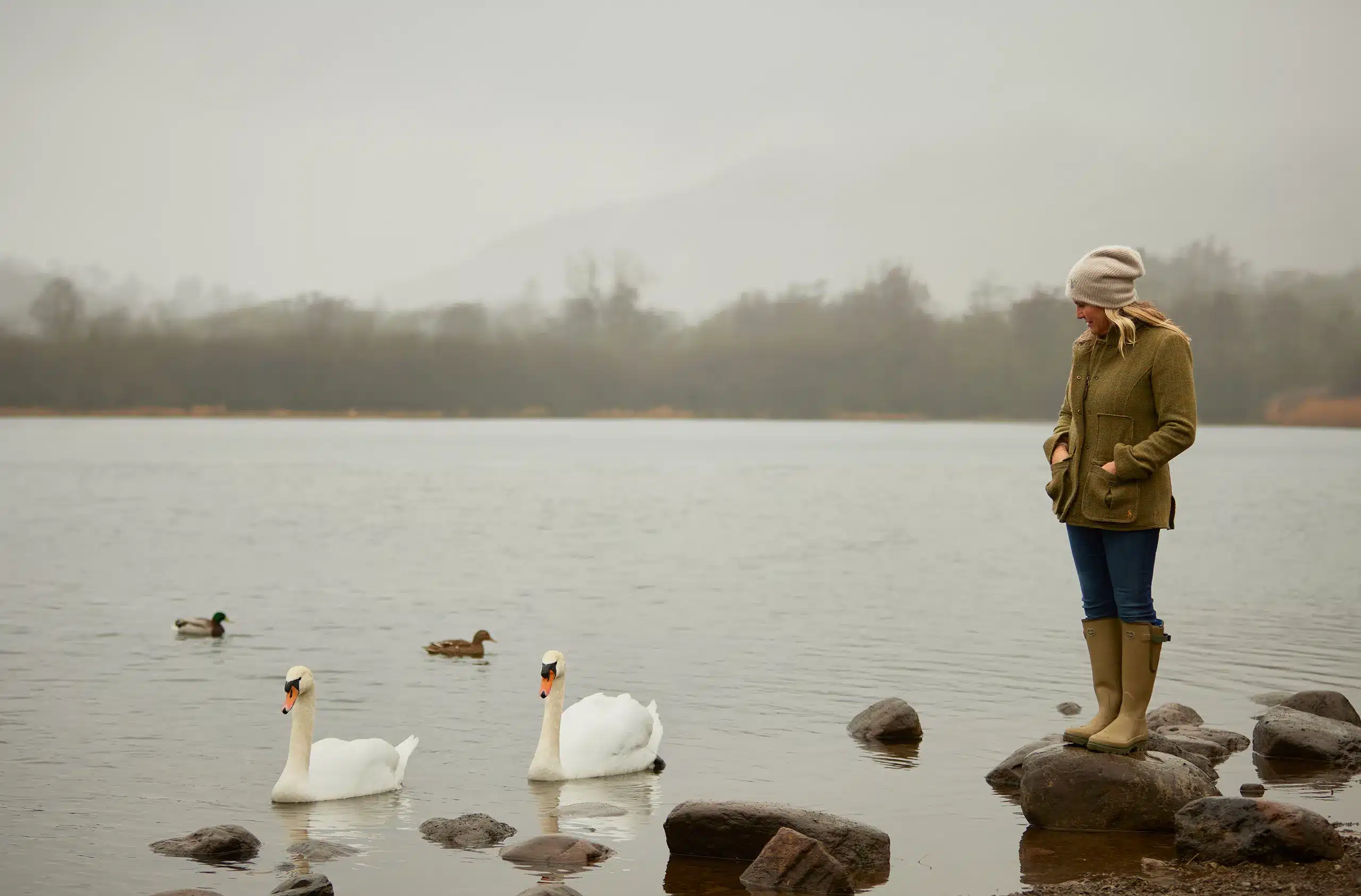 katharine pooley, the uks best interior designer, near her home in the lake district with some swans