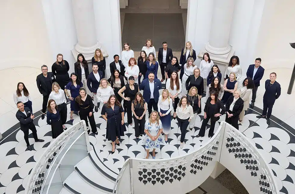 A staff picture of the katharine pooley team taken at the tate britian, a museum and gallery in central london