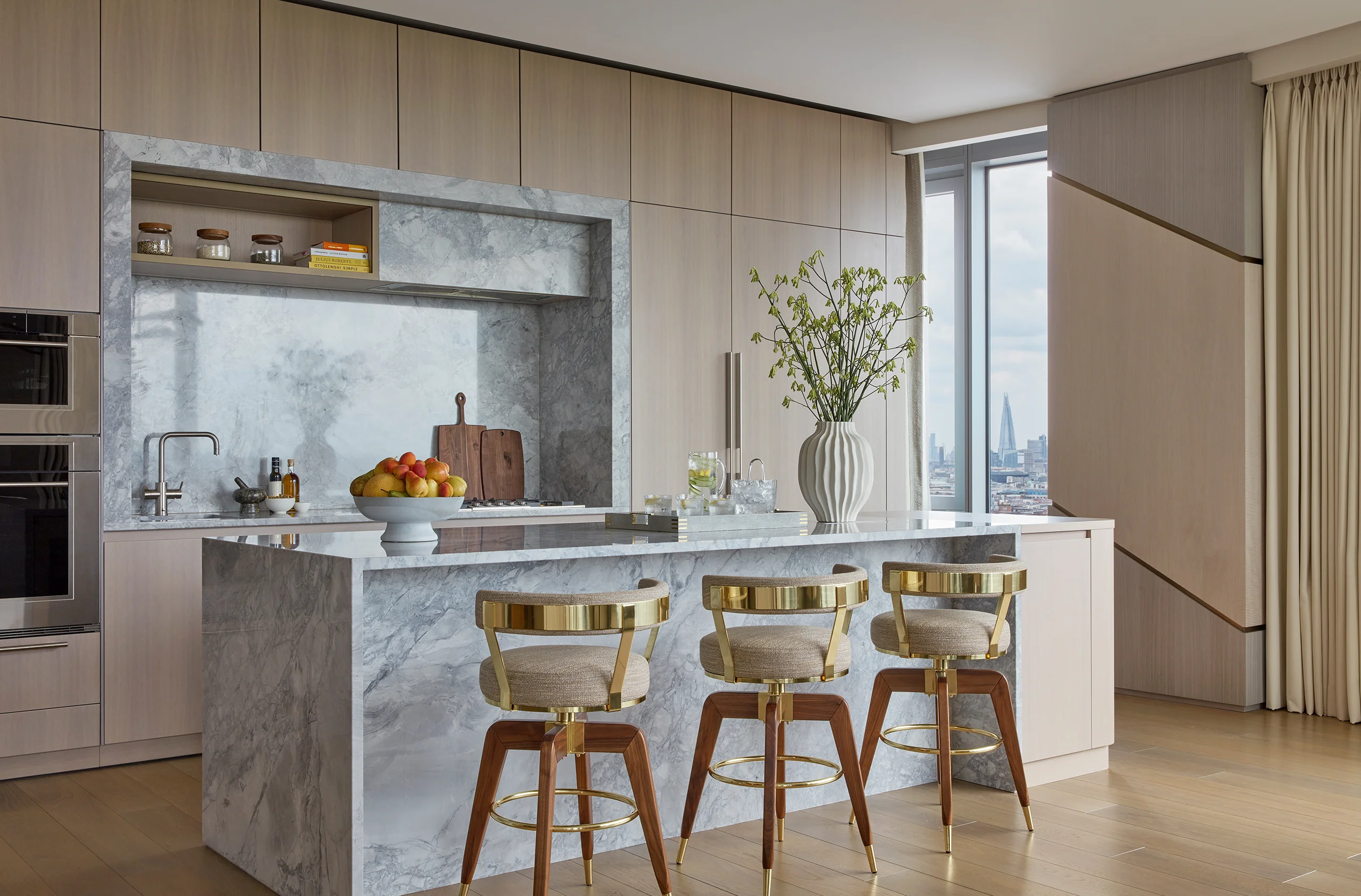 A minimalist contemporary kitchen with striking marble island in a katharine pooley interior design project