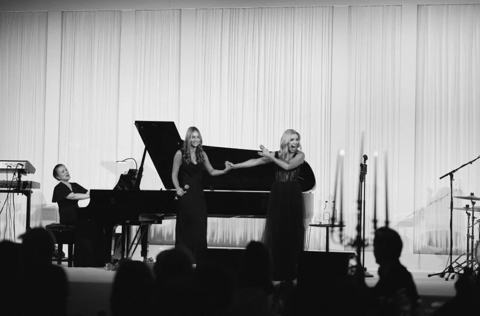 Katherine Jenkins stands on stage with a young lady after she invited her to perform a duet