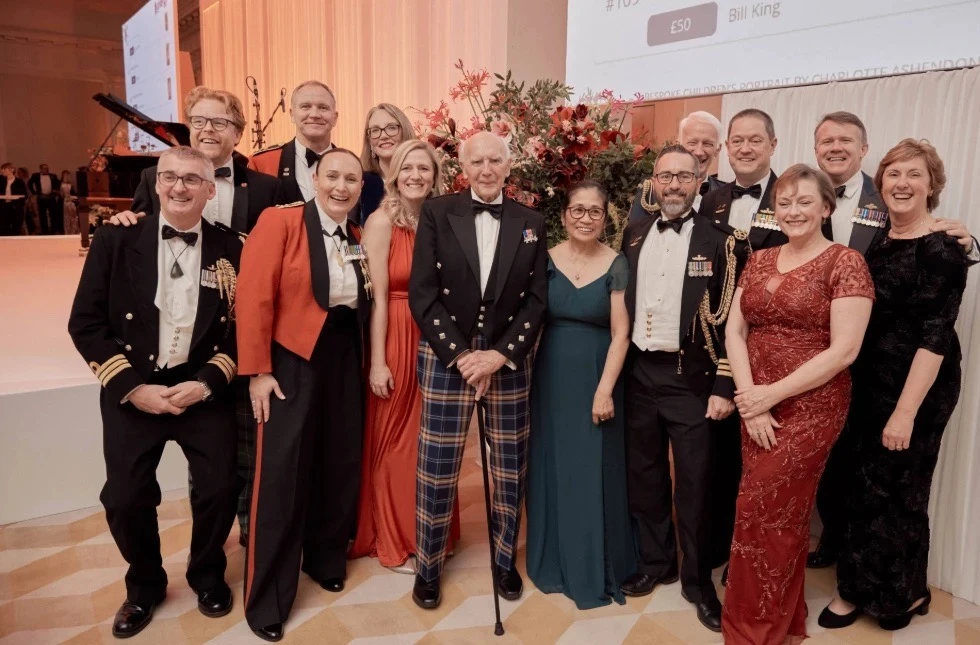 Robert Pooley is joined by a group of attendees at the British Forces Foundation Ball