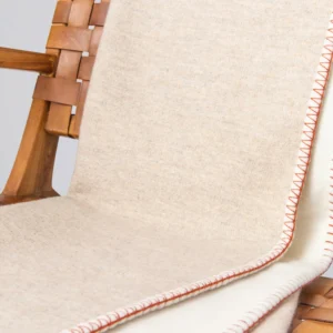 A ecru reversable throw with stitching detail by katharine pooley and johnstons of elgin