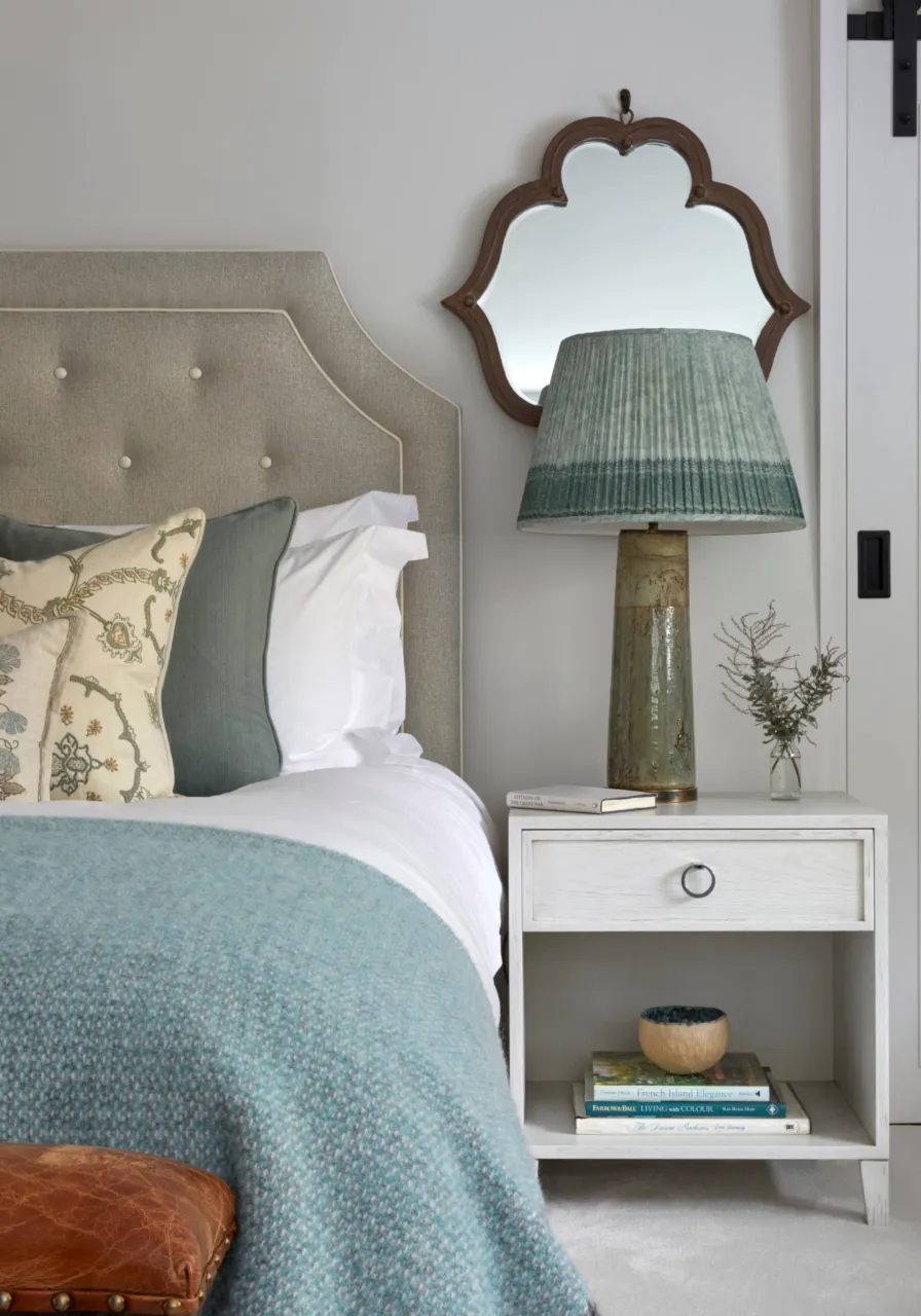 A styled bedside table in a countryside estate home by katharine pooley